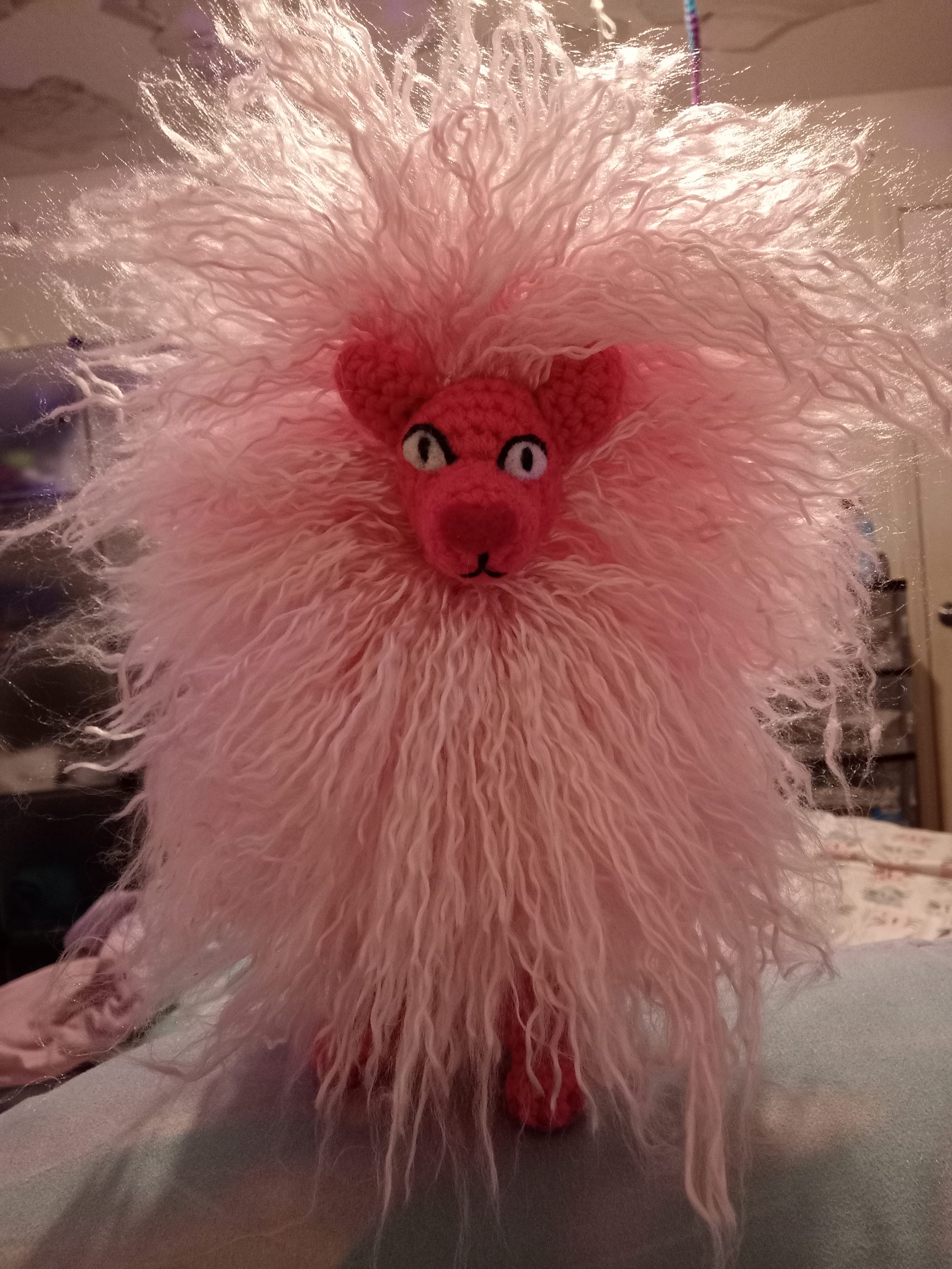 a front view of a crocheted Lion from Steven Universe with a super frizzy mane that sticks out in every direction